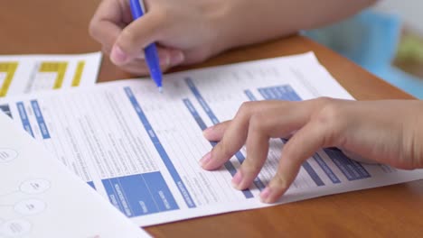 a student diligently fills important academic paperwork a bright classroom setting