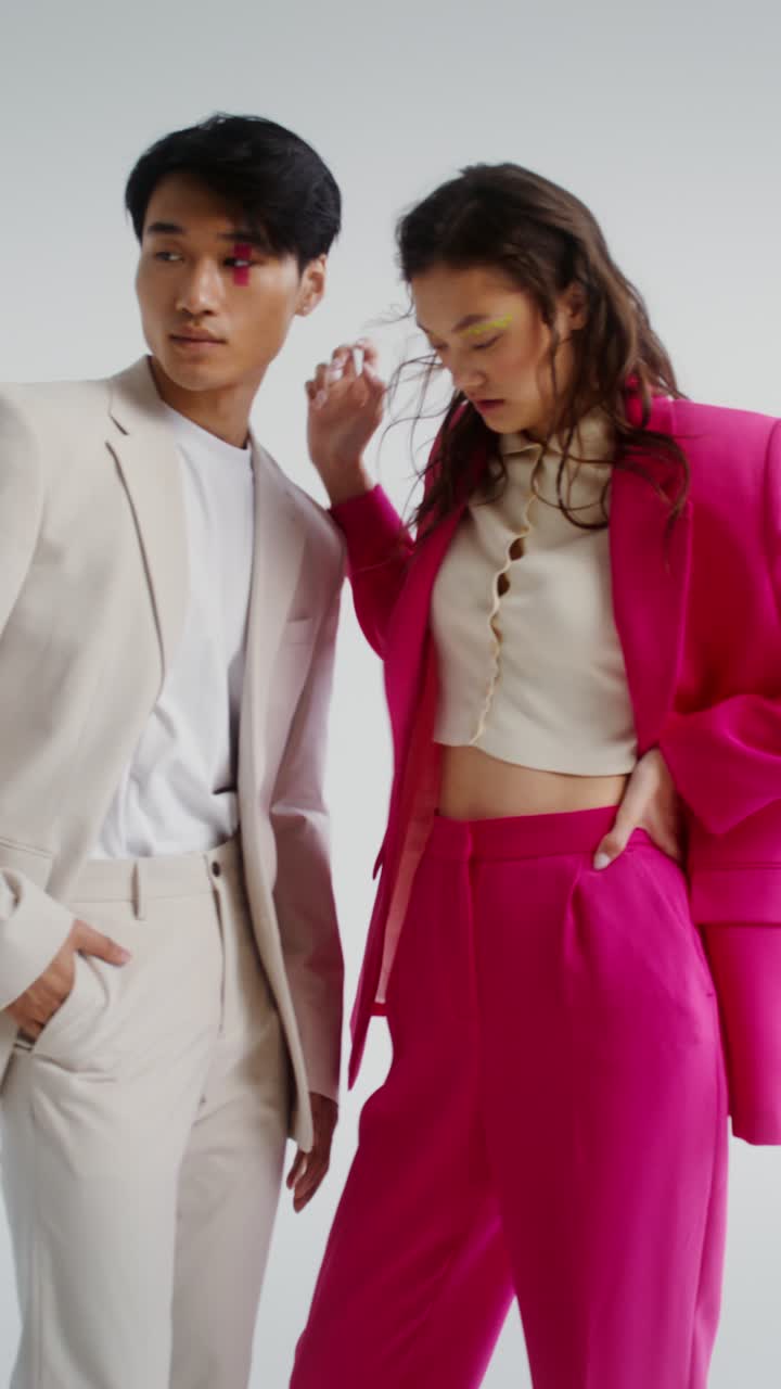 Fashionable Couple Posing in Suits