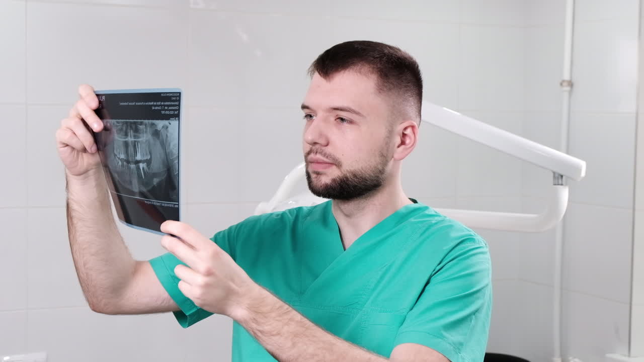 Doctor in the dental office checking and explaining x-ray test