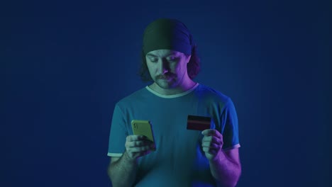 man using mobile phone and credit card