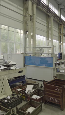 interior view of an industrial factory or workshop with various machines and storage containers