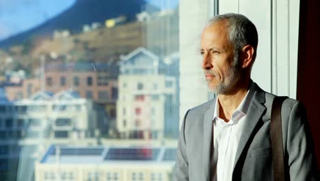 businessman looking outside the window in hotel room 4k