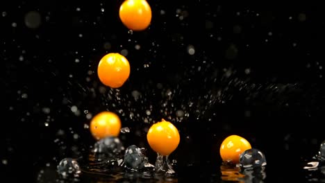 Strawberries-and-berries-falling-on-water-against-black-background-4k