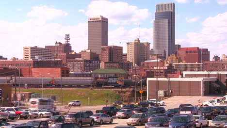 Omaha-Nebraska-skyline-by-day-with-trains-and-trucks-moving-freight-foreground