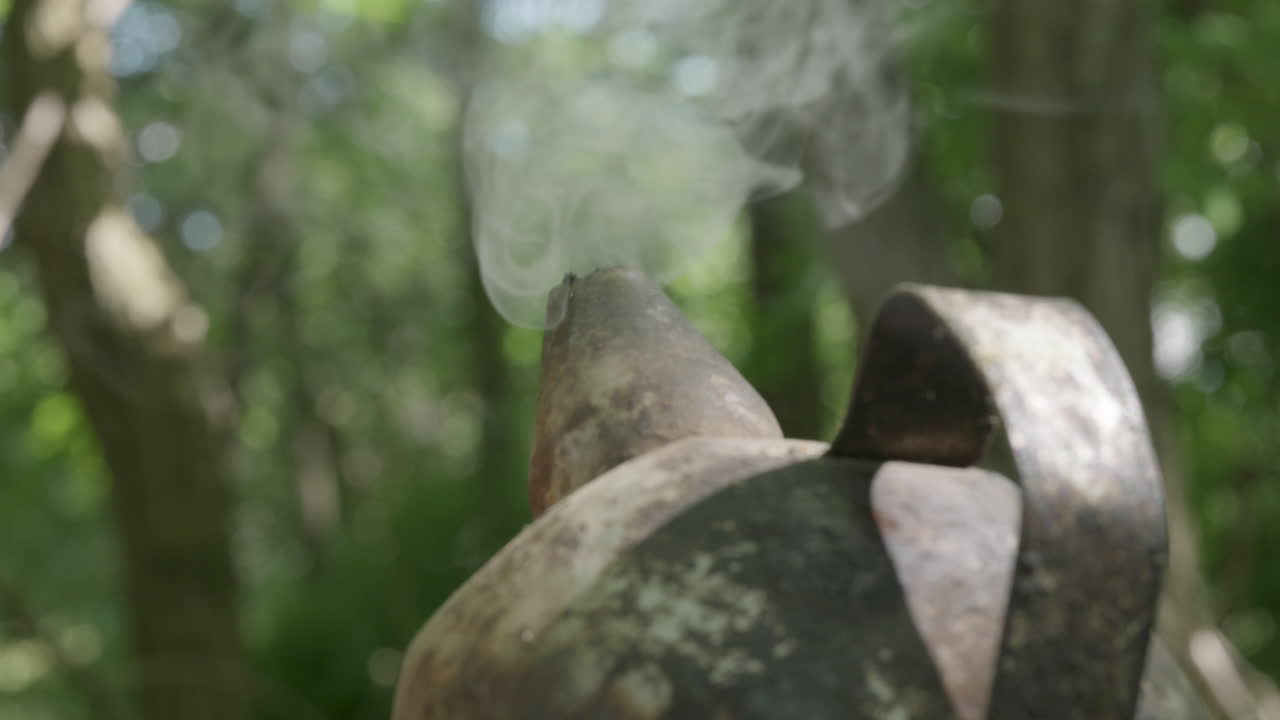 Smoke rising from active beekeeping smoker
