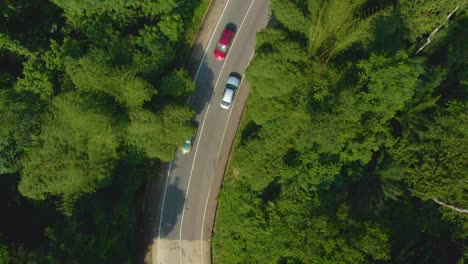 Birds-eye-view-of-car-on-curve-road-up-the-hill