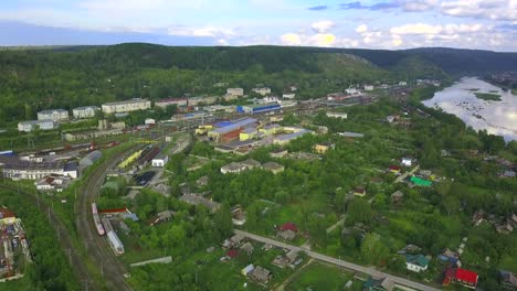 aerial view of a city with a river and train station