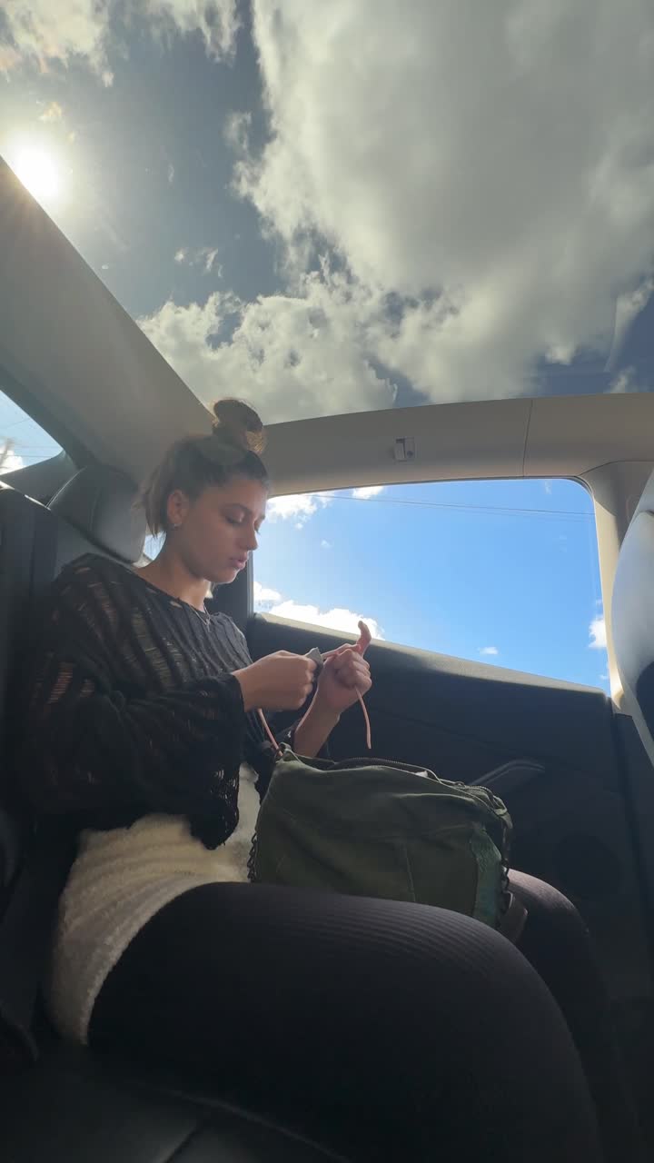 Woman in car looking out sunroof