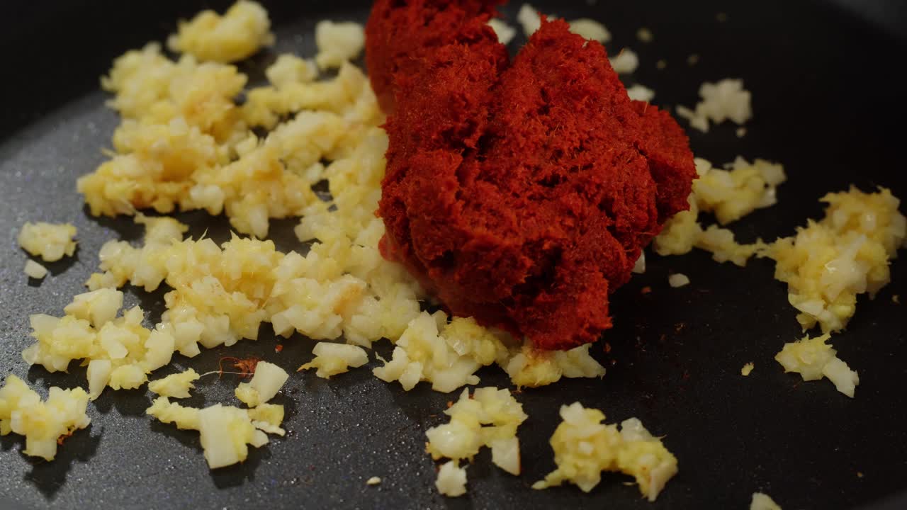 Peeled and Finely Chopped Ginger or garlic Root, Diced ginger on a wooden cutting board prepared for stew grill