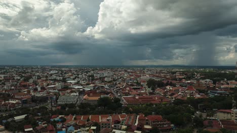 storm brews above siem reap cityscape in cinematic aerial timelapse