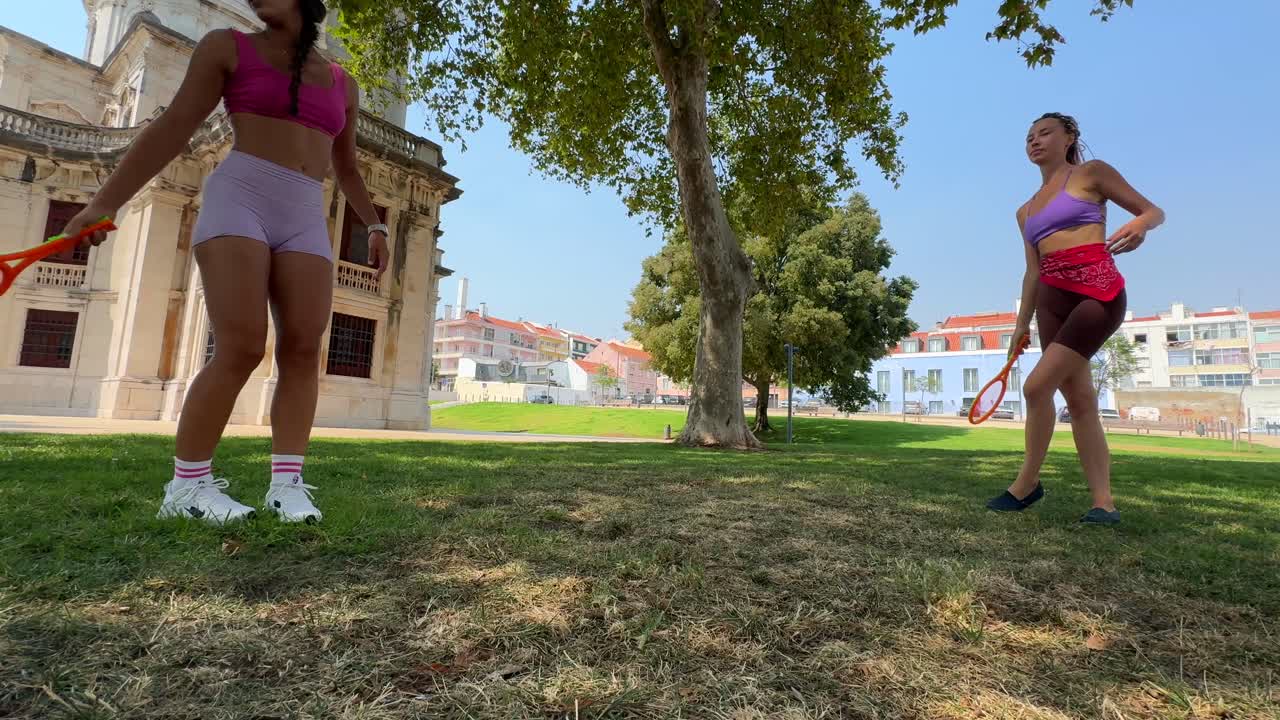 Women playing badminton in a park