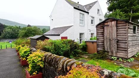 scenic garden path beside rustic buildings