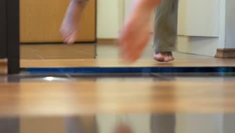 woman feet dancing barefoot in front of mirror in apartment