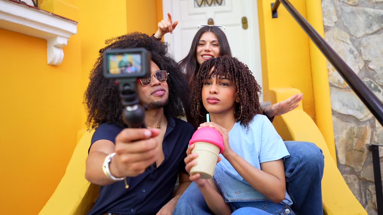 A group of people filming a vlog on the stairs