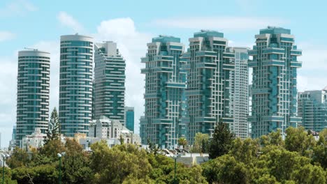 boutique residential apartment buildings with blue sky and puffy clouds in the background