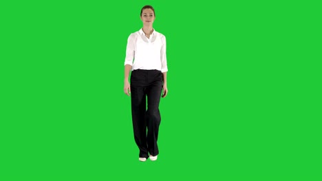 woman walking in formal outfit on a green screen, chroma key