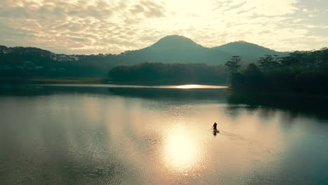 sunrise kayaking on a mountain lake