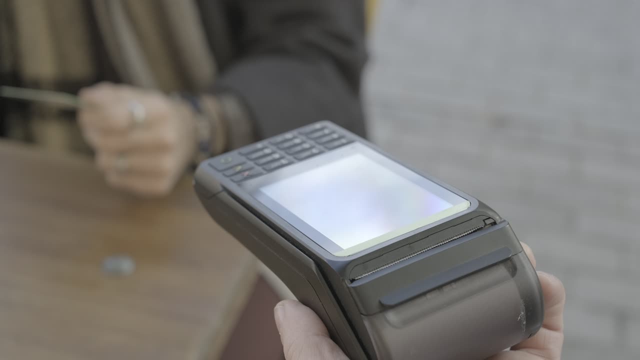 Images of a person using a POS terminal to make a payment