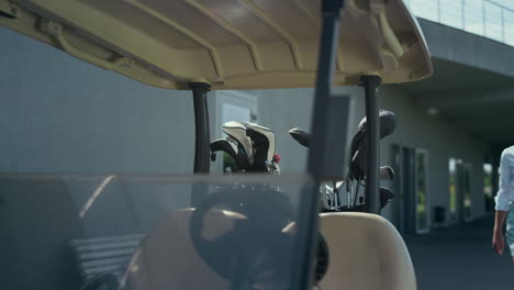 woman walking golf cart at country club field. golfing player enjoy sunny day.