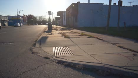 Slow-motion-Dolly-shot-orbiting-curb-on-the-East-side-of-Detroit-during-the-evening