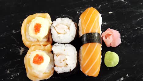 Set-of-assorted-sushi-served-on-gray-stone-slate