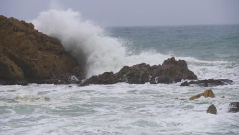 sea storm in blanes giant waves in super slow motion breaking against the rocks mediterranean sea costa brava winter cloudy day