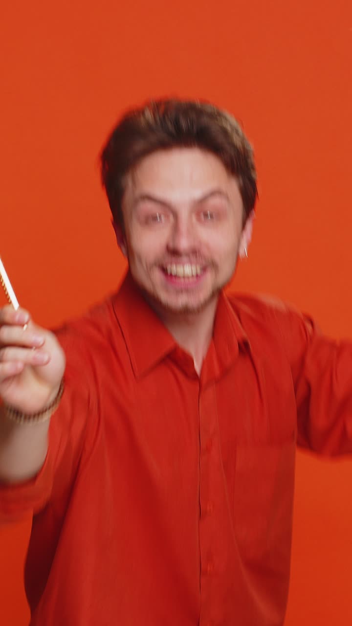 Magician wizard young man gesturing with magic wand making wish come true casting magician spell