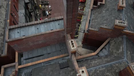 Aerial-drone-flight-over-the-rooftop-of-London-Road-Fire-Station-under-refurbishment-giving-a-slow-reveal-of-Piccadilly-Train-Station