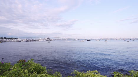 new england bay with many ships with waves crashing up on the coast