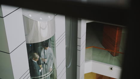 business people in an elevator