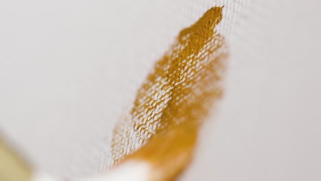 closeup of an artist painting with a brush