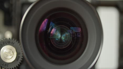 close up shot of the front of a cinema lens, iris opening and closing