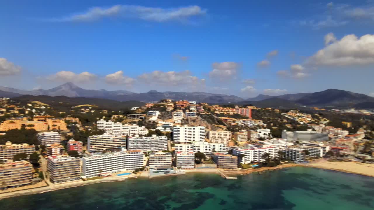 Experience the breathtaking beauty of Santa Ponsa in Mallorca, showcasing stunning coastal views, luxurious resorts, and surrounding mountains under a clear blue sky.