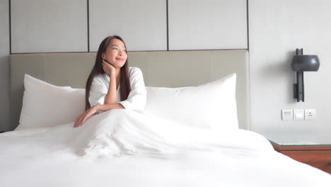 soulful asian woman waking up to sunlight happily