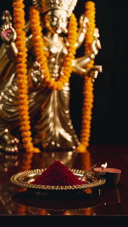 hindu prayer with statue and incense