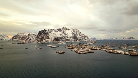 Aerial-sideways-view-of-snowcapped-Henningsvær-or-Henningsvaer-archipelago-of-Lofoten-islands-in-northern-Norway