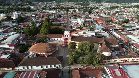 orbital drone shot showing the moorish style arch of the city of san cristobal de las casas in chiapas mexico