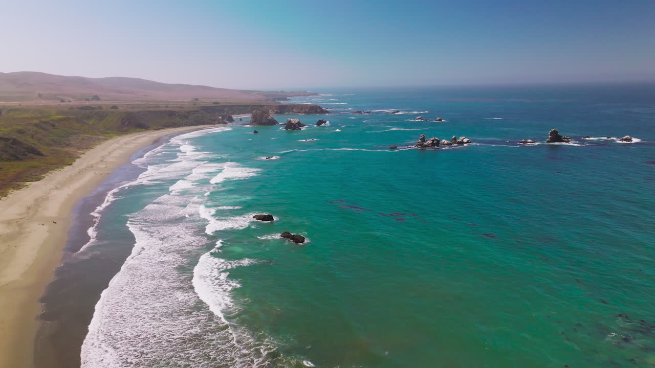 Amazing view of azure scenery of the ocean. Lovely sight of waves arriving to the rocky coastline of Morro Bay, California, USA.