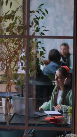 woman working on laptop in a cafe