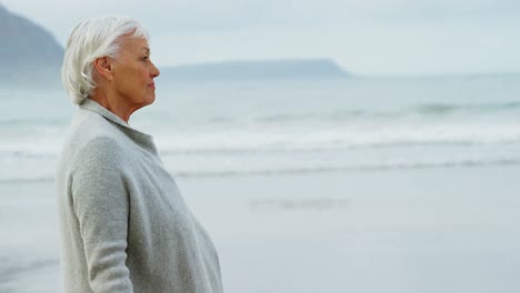 Senior-woman-walking-on-beach