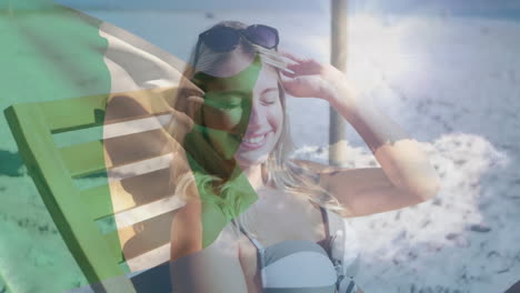 relaxing on beach, woman with irish flag animation overlay, smiling contentedly