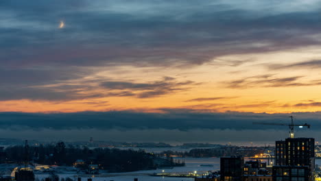 evening to night timelapse of sea fog and dusk with a moon crescent in helsinki