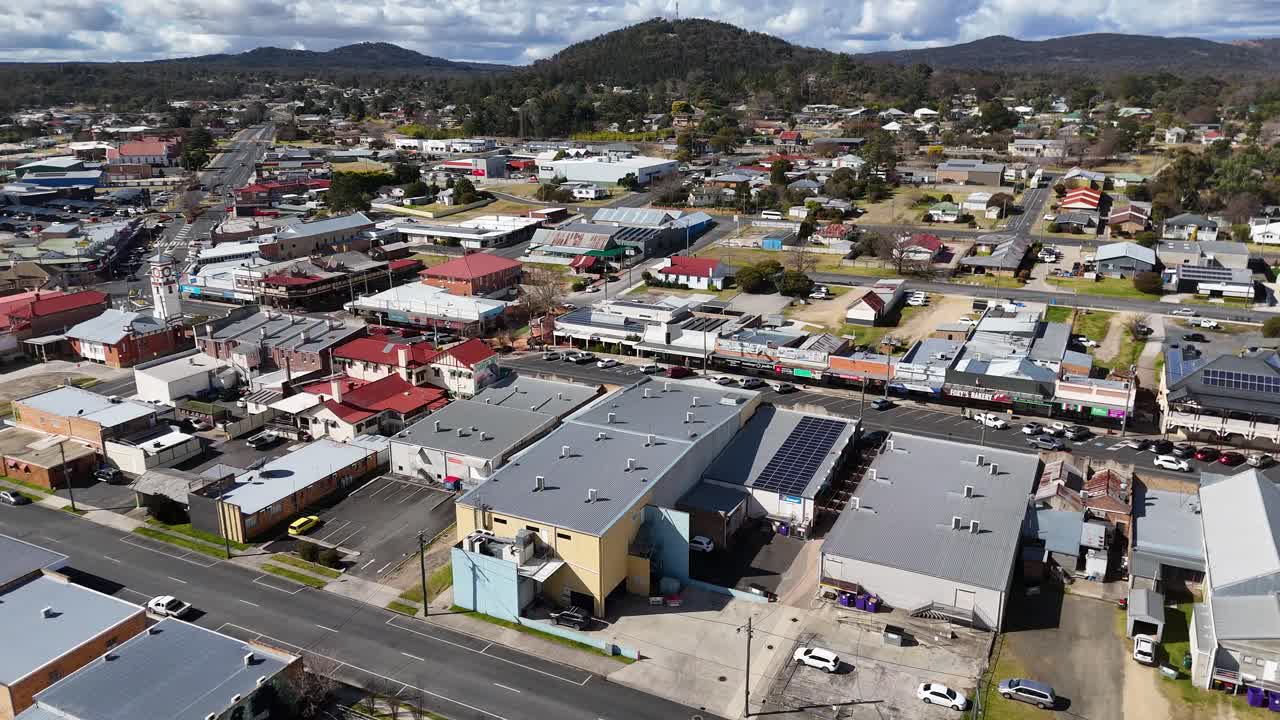 Urban residential area with houses, parked cars, and businesses