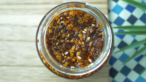 chili and garlic flakes in a container made with coconut oil