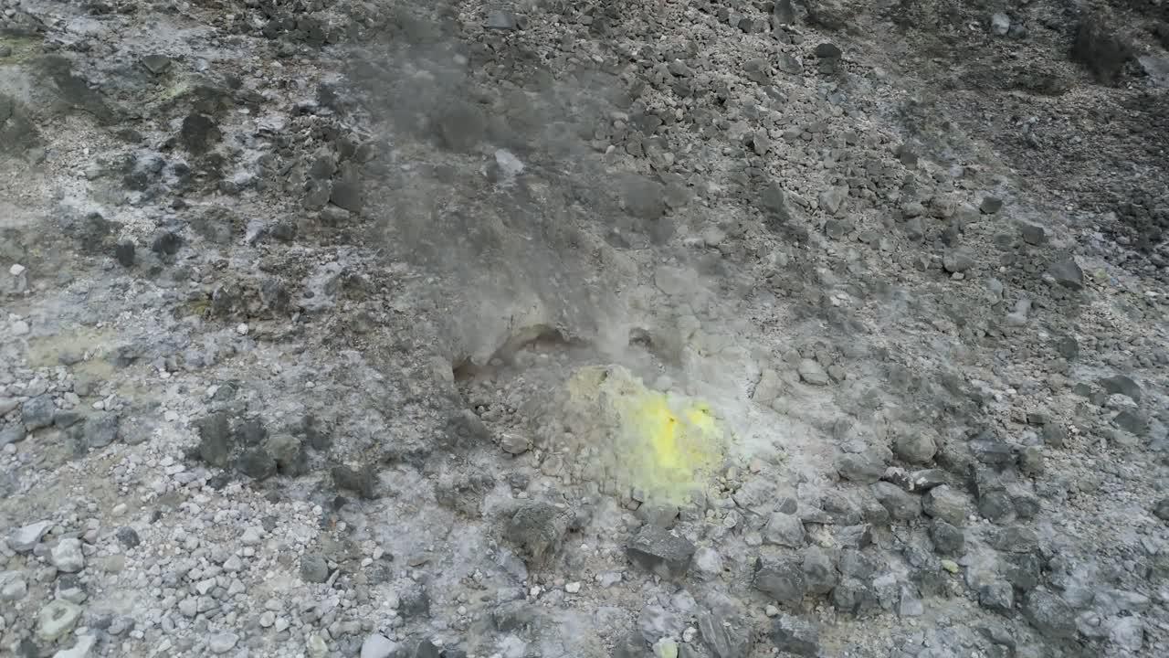Drone view of natural vents of Mount Sibayak volcano, each releasing thick streams of smoke