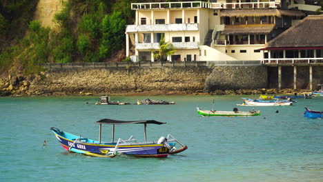 indonesian fishing traditional asian boat moored in tranquil bay at day time