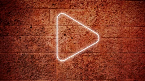 animation of glowing neon play button icon on brick wall