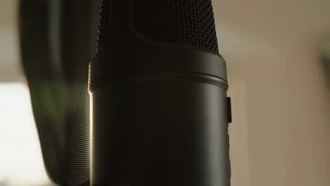 close-up of a black microphone with a pop filter