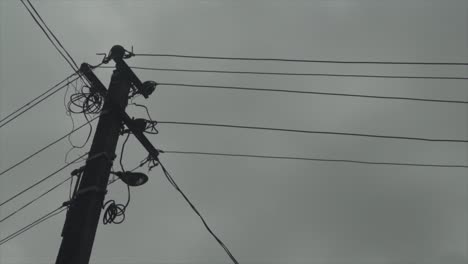 Electric-pole-power-equipment-revealing-shot-with-wiring-stretching-across