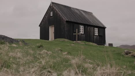 black church krýsuvíkurkirkja in reykjanes peninsula, iceland - tilt up